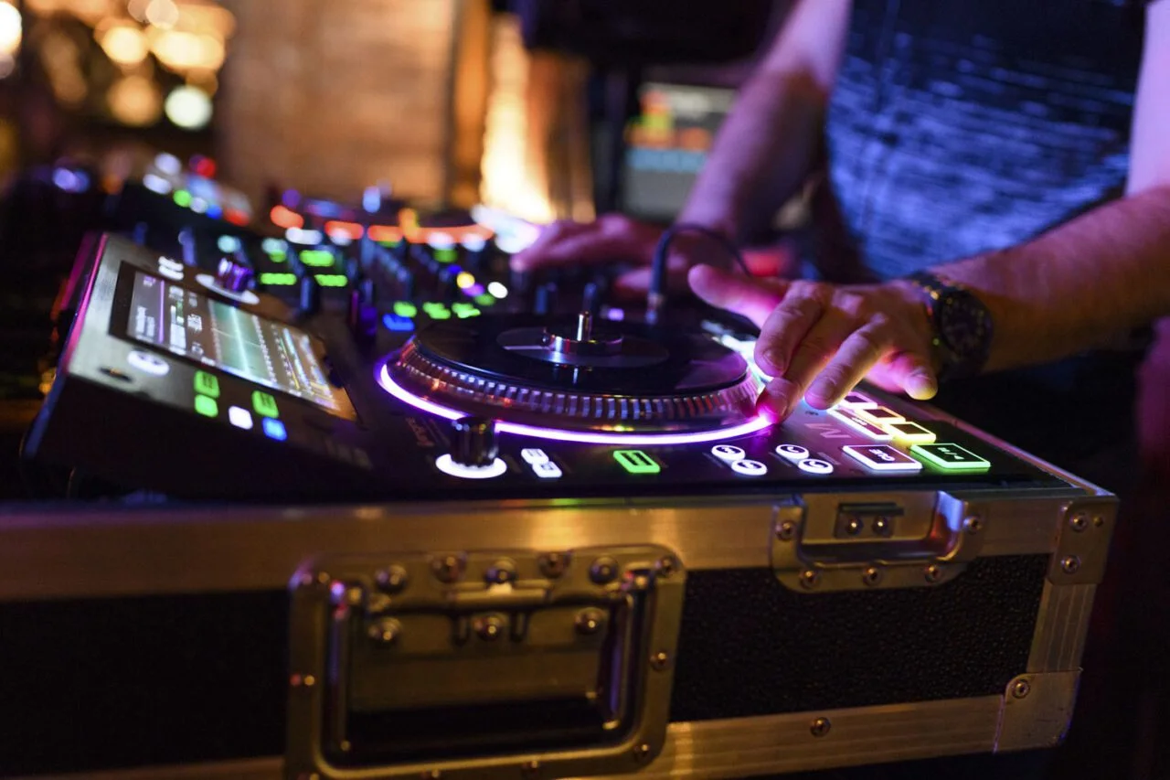 Detail práce DJ PMC s mixážním pultem
